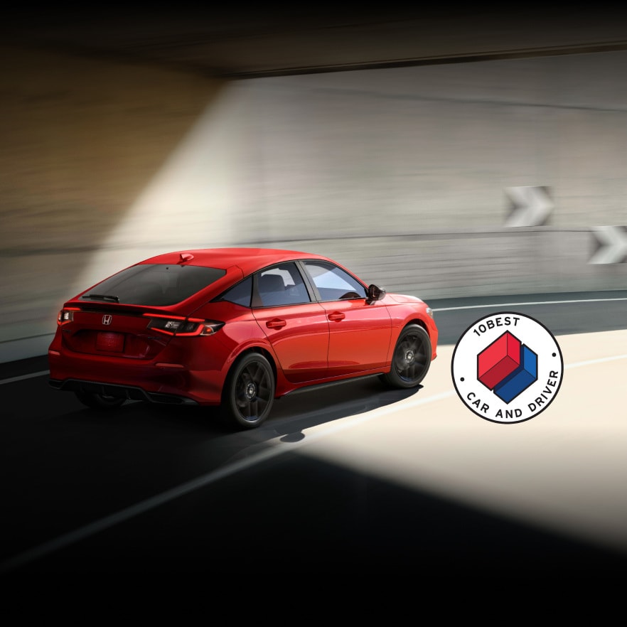 2026 Honda Civic Hatchback Sport driving through a sunlit tunnel
