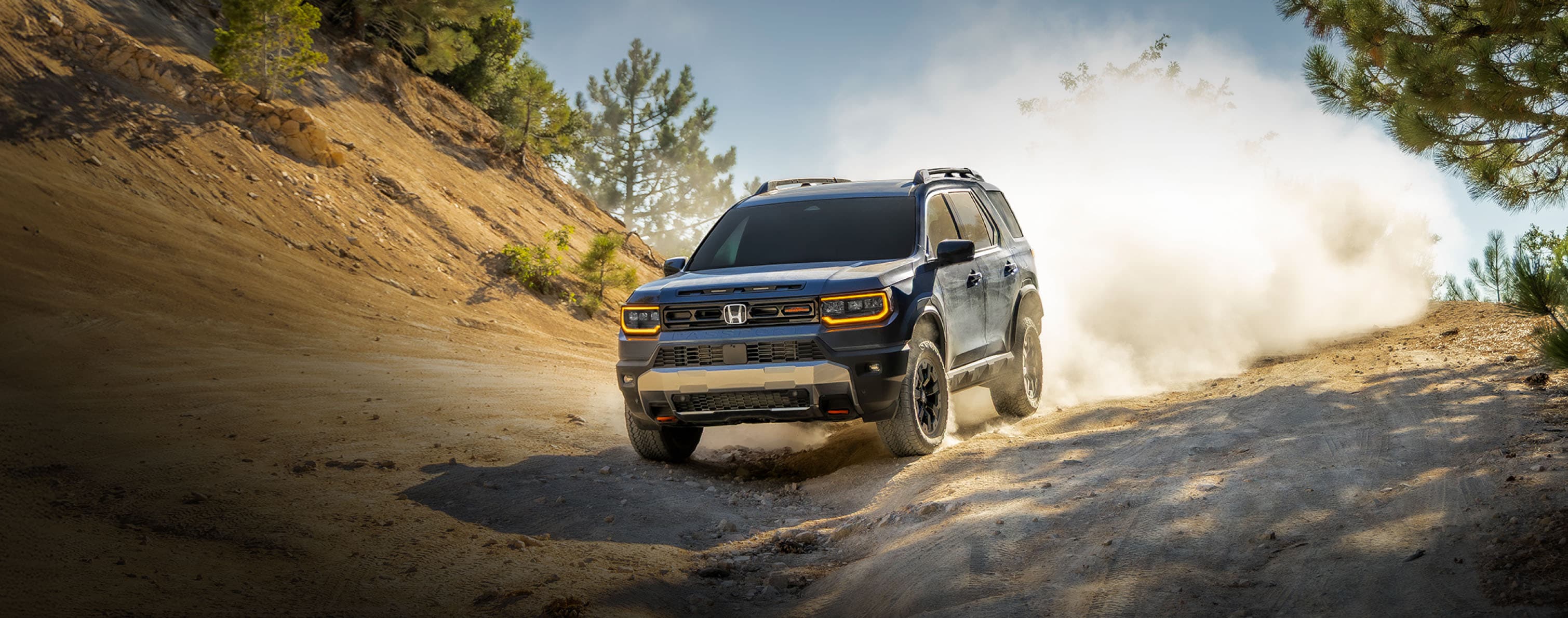 2027 Honda Passport TrailSport Elite driving on an off-road trail