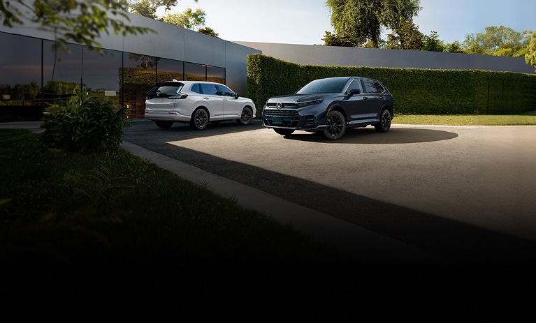 2026 Honda CR-V and Honda Prologue front and back profile parked outside a modern building.
