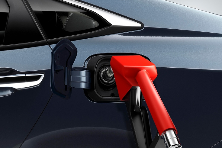 2026 Honda Civic in Blue Lagoon Pearl profile at a gas station (All-Electric SUV).