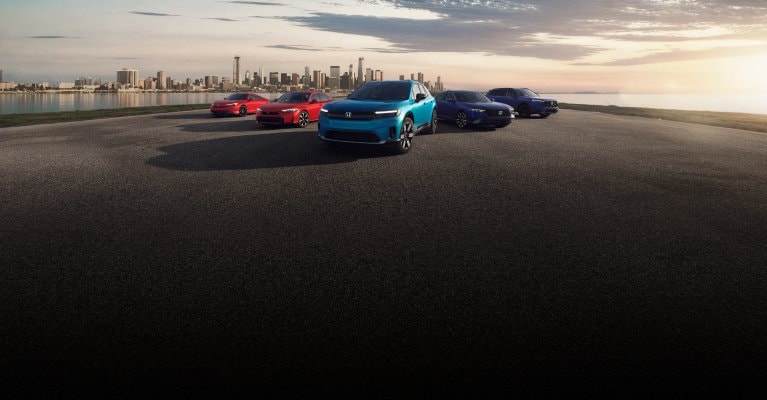 2026 Honda Electrification lineup parked with the city far in the background, showing Prelude, Civic Sedan, Prologue, Accord and CR-V.