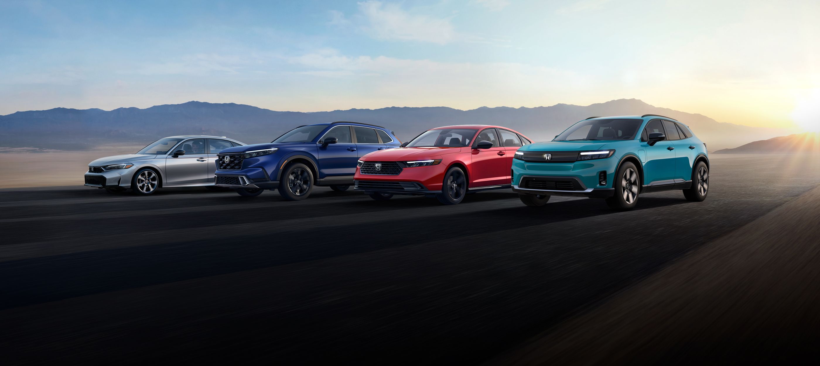 2024 Blue Honda Prologue, Blue CR-V, and red civic EV's driving in tandem on highway
