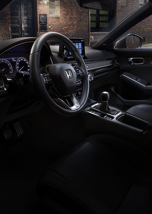 Interior driver-side view of the 2022 Honda Civic Sport Touring Hatchback with Black Leather.