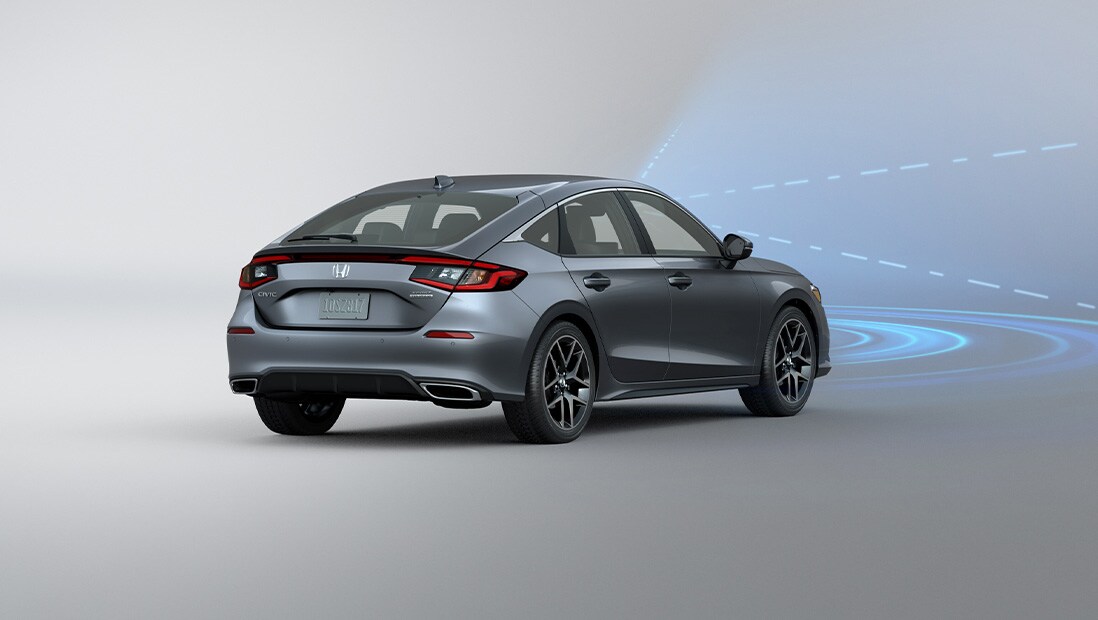 Rear passenger-side view of the 2022 Honda Civic Sport Touring Hatchback in Sonic Gray Pearl with illustrated lines demonstrating Honda Sensing® feature.