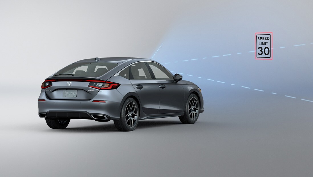 Rear passenger-side view of the 2022 Honda Civic Sport Touring Hatchback in Sonic Gray Pearl with illustrated lines demonstrating Honda Sensing® feature.