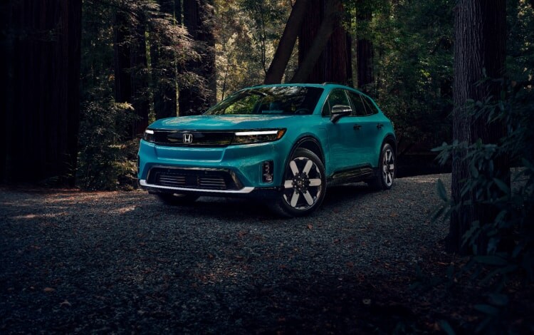 2024 Honda Prologue Elite shown in North Shore Pearl with Honda Genuine Accessories parked in Redwoods in dusk lighting.