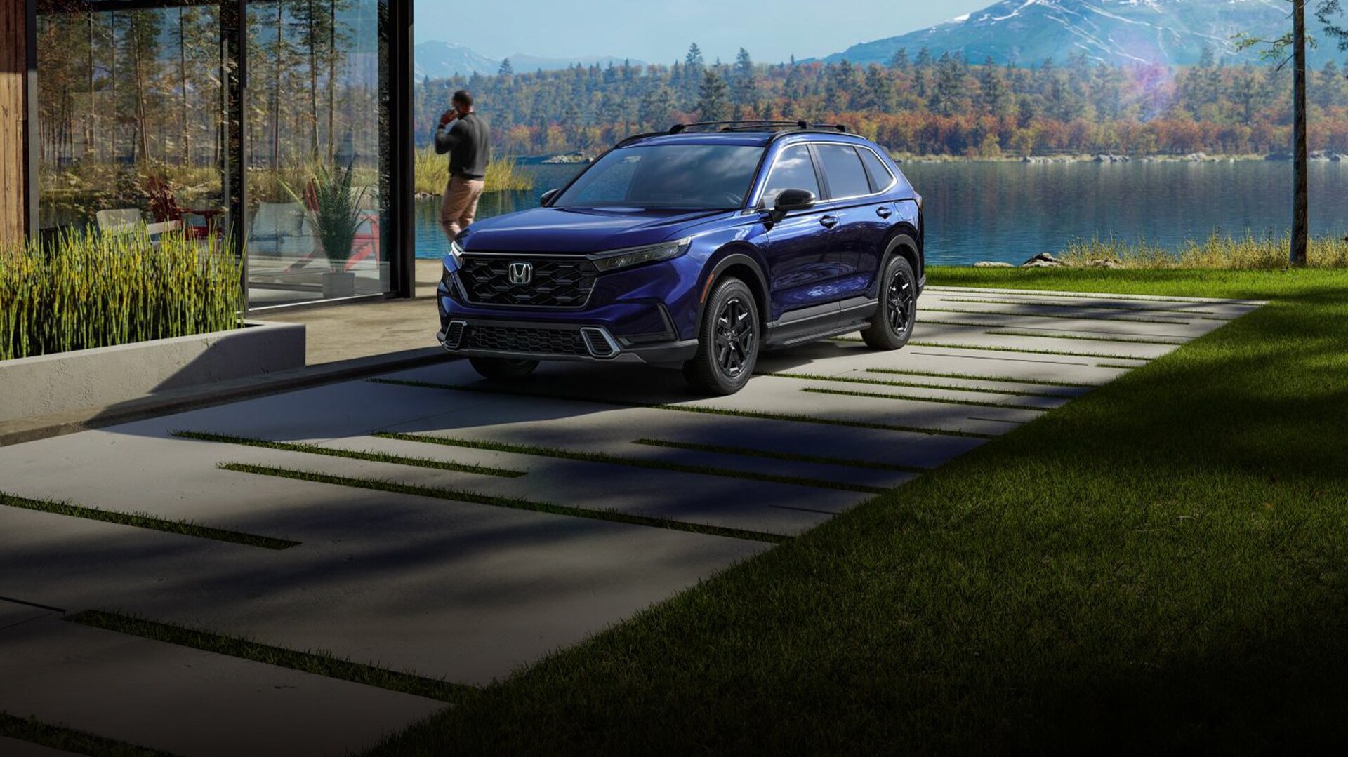 2025 Honda Sport Touring Hybrid in Canyon River Blue Metallic, 3/4 front driver of vehicle parked in the driveway of a lake front home with a person