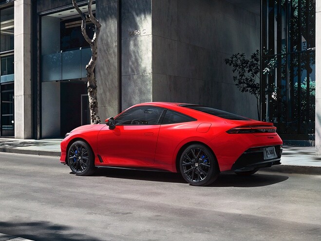 2026 Honda Prelude in Rallye Red, 3/4 rear view, parked alone the street in the down town.