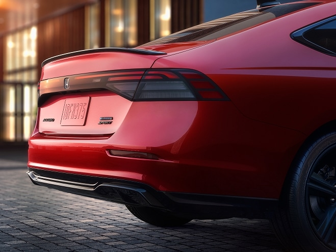 Rear shot of 2026 Honda Accord in Radiant Red Metallic showing Rear Spoiler and Rear Diffuser detail.