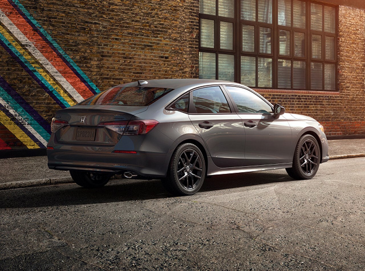 2026 Honda Civic Sedan Sport in Meteorite Gray Metallic, rear 3/4 view