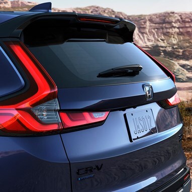 2027 Honda CR-V Sport Touring Hybrid in Canyon River Blue Metallic back parked in a scenic desert canyon (Compact Crossover SUV).