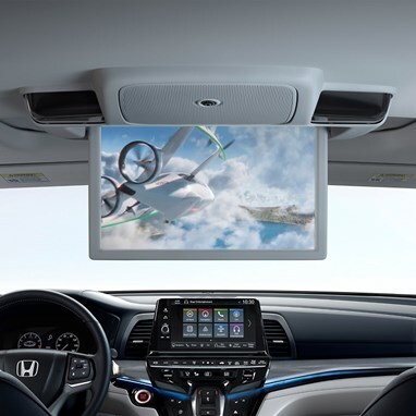 2027 Honda Odyssey trim rear entertainment screen playing video inside the spacious van 3 row cabin layout (Minivan).