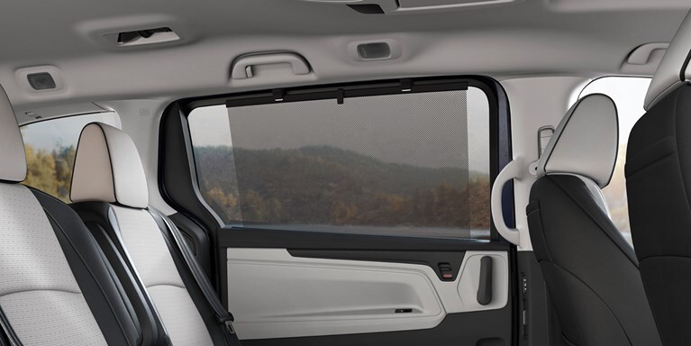 2027 Honda Odyssey Elite rear passenger seats featuring an integrated window sunshade (Minivan).