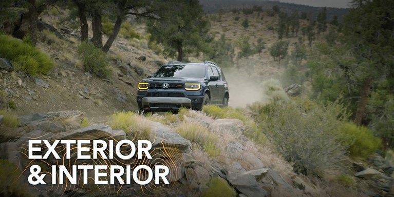 2027 Honda Passport TrailSport Elite in Smoke Blue Pearl front driving on a rugged rocky dirt trail (Mid-Size SUV).