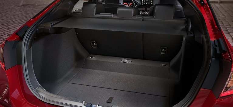 2027 Honda Civic Hatchback Sport Touring Hybrid spacious cargo area with rear seats up and cargo cover (Compact Hatchback).