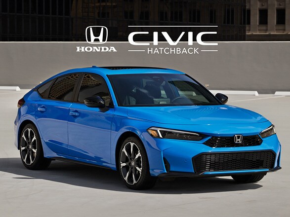 2027 Honda Civic Hatchback Sport Touring Hybrid in Boost Blue Pearl profile on a rooftop parking lot with city buildings (Compact Hatchback).
