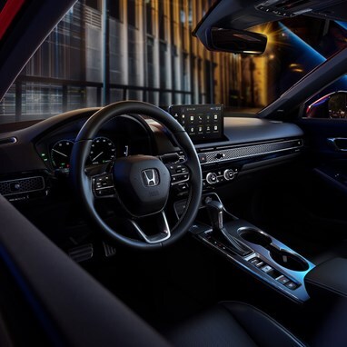 2027 Honda Civic Sedan Sport Touring Hybrid dashboard and center console view at night (Compact Sedan)