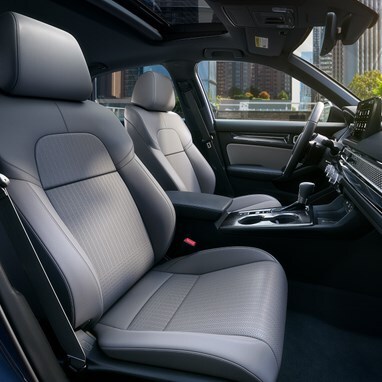2027 Honda Civic Sedan Sport Touring Hybrid front seats and dashboard view in a city (Compact Sedan)