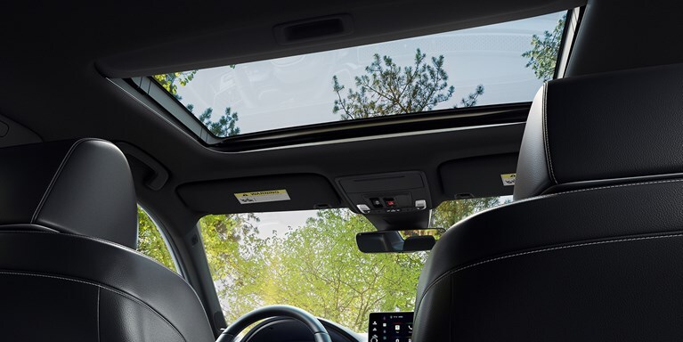 2027 Honda Civic Sedan Sport Touring Hybrid interior view from rear seat showing moonroof and dashboard (Compact Sedan)