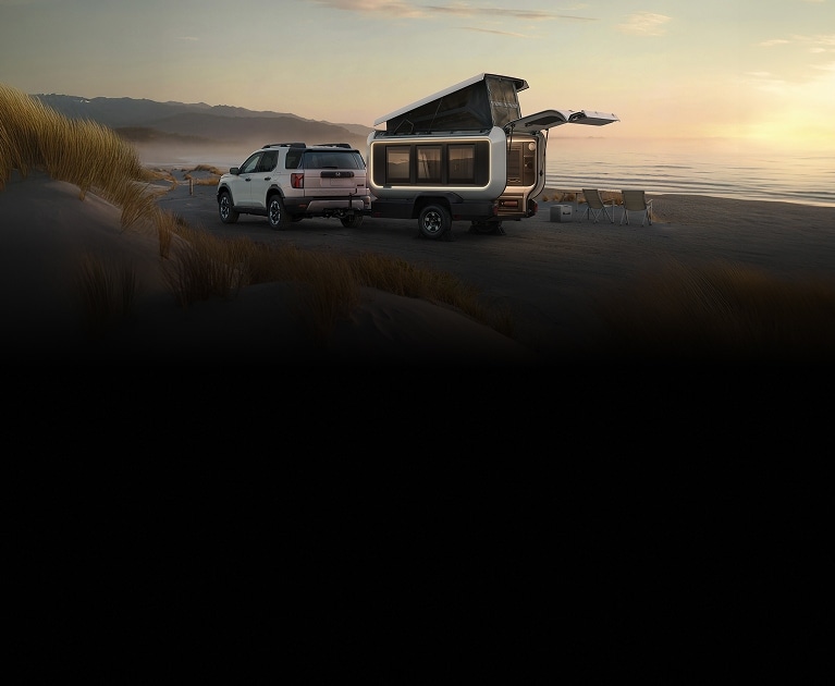 2026 Honda Base Station back on a sandy beach with dunes and ocean at sunset.